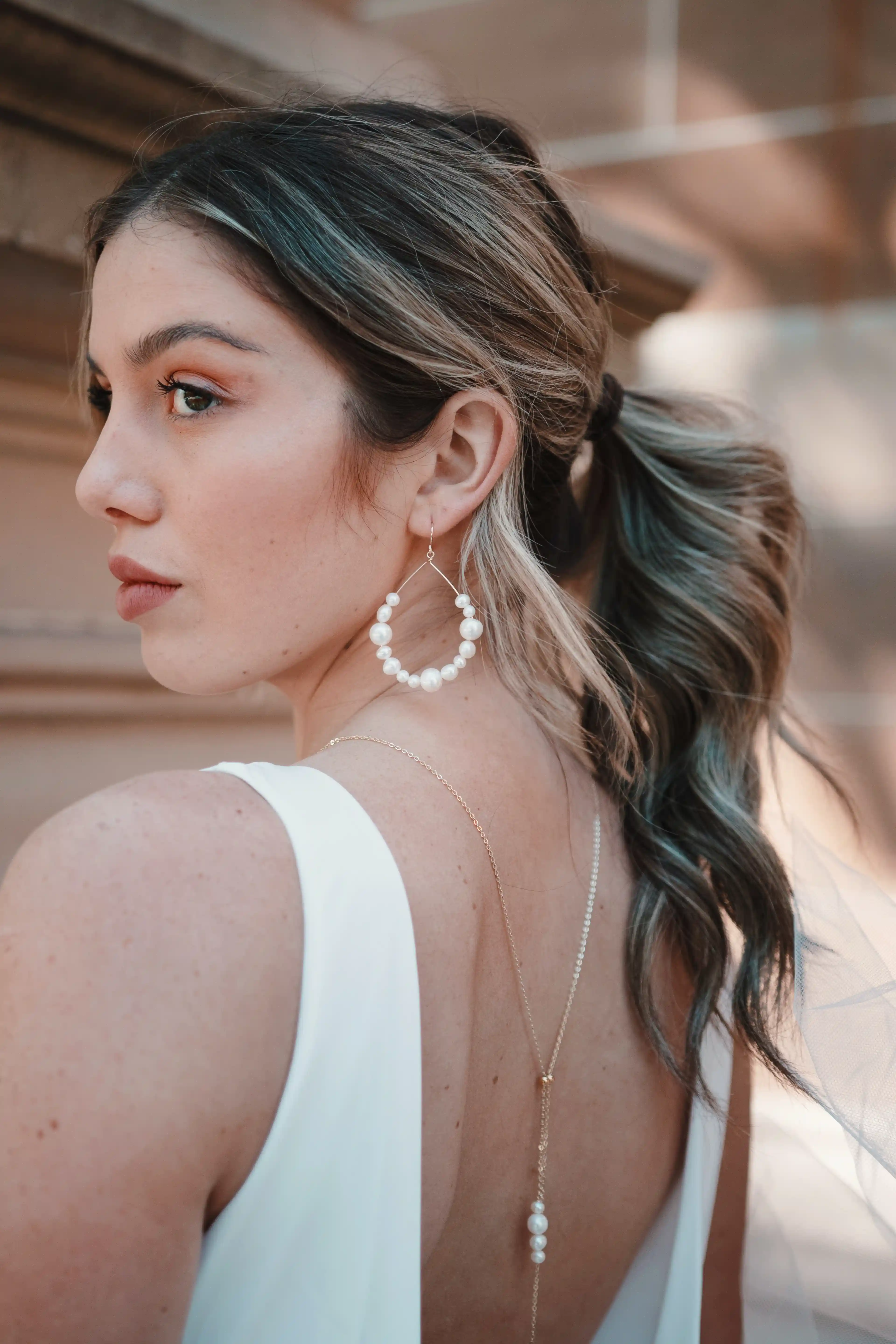 woman in white tank top wearing silver necklace